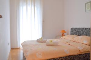 a bedroom with a bed with two stuffed animals on it at Apartment Silvija sea view in Umag