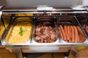 a buffet of food in a toaster oven at Penzion Hviezda in Bratislava