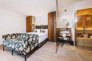 A bed or beds in a room at Nikolaus by AvenidA Panoramic Wellness Suites