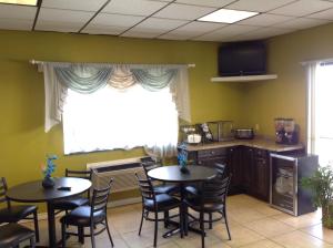 a waiting room with two tables and a window at Executive Inn Tulia in Tulia