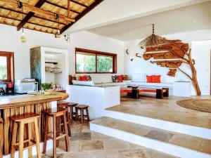 a kitchen and living room with a table and chairs at Villa Pinolo by Kabana in Prea