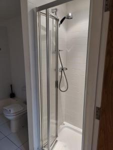 a bathroom with a shower and a toilet at Cornhill Apartment by Serviced Living Liverpool in Liverpool