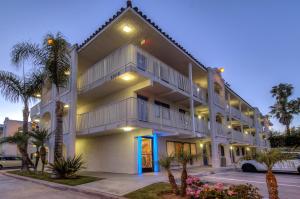 a large white building with a blue door at Motel 6-Oceanside, CA in Oceanside