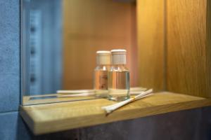 a bathroom shelf with two bottles and a mirror at Bella Gondola Zlatibor in Zlatibor