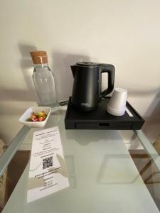 a coffee pot and a bowl of fruit on a glass table at Hotel Casa Socotor in Sallent de Gállego