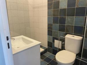 a bathroom with a toilet and a sink at appartement neuf style architecte au calme in Compiègne