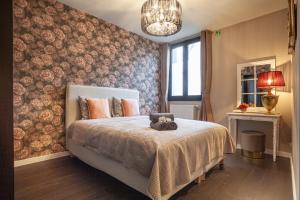 a bedroom with a bed with a teddy bear on it at Luxury Suites Royal in Antwerp