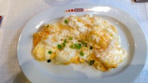 a plate of food with mashed potatoes on a table at Hotelik Gościnny in Radzyń Podlaski
