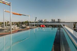 a swimming pool on the roof of a building at Brucklyn Suites in Erlangen