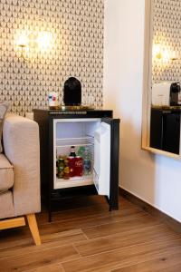 an open refrigerator in a living room next to a couch at Risorgimento 55 in Rome