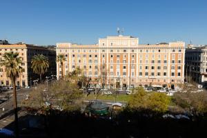 a large white building with palm trees in front of it at Risorgimento 55 in Rome