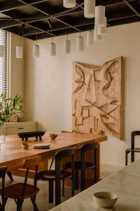 a dining room with a wooden table and chairs at Warszauer Hotel in Krakow