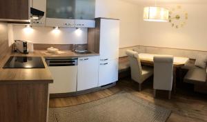 a small kitchen with a table and a dining room at Gielerhof in Zell am Ziller