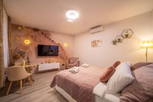 a bedroom with a bed and a desk and a tv at Cosy&Private,30sec walk to MainSquare, Heart of Zagreb in Zagreb