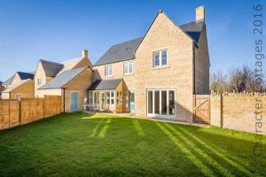 a large brick house with a large yard at Honeystones in Bourton on the Water