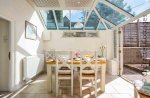 a dining room with a table and two chairs at Weir Cottage in Bourton on the Water