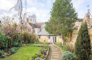 a garden in front of a stone house at Lanes Cottage in Chipping Campden