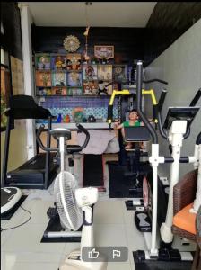 a room with a gym with several exercise equipment at Wiang Kum Kam Resort in Chiang Mai