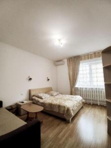 a bedroom with a bed and a large window at Славутич in Polyana