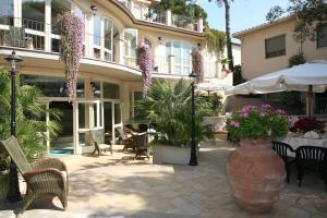 a large vase with purple flowers in front of a building at Hotel Atlantico in Castiglioncello