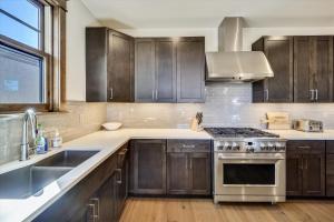 a kitchen with stainless steel appliances and wooden cabinets at Cocoa Cabin home in Breckenridge +41 photos