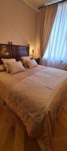 a bedroom with a large bed with a window at Al Molo di Sant'Agostino in Como