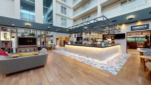 a lobby with a bar in a building at Holiday Inn Milton Keynes Central, an IHG Hotel in Milton Keynes