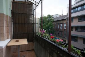 a balcony with a table and flowers on a building at Mamma's Apartment in Budapest