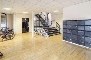 a gym with bikes parked in a room with a staircase at The Holkham in Leicester