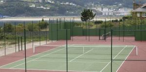 a tennis court with two tennis nets on it at Hotel Las Sirenas in Viveiro