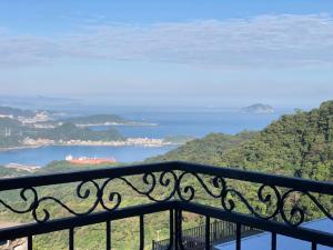 a view of the ocean from a balcony at Sunshine B&B in Jiufen +91 photos