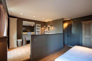 a bedroom with a bed and a kitchen with a counter at Château de Planchevienne in Magny-Cours