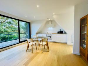 a kitchen and dining room with a table and chairs at La Maison Rouge in Steenwerck