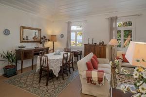 a living room with a couch and a table and chairs at Casa dos Terços by An Island Apart in São Vicente