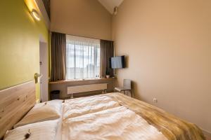 Katil atau katil-katil dalam bilik di Hotel Miķelis