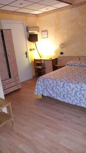 Postel nebo postele na pokoji v ubytování Albergo Sangrilà