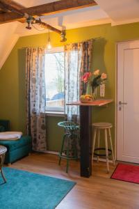 a living room with a table and a window at Maisonette am Glockenturm in Südbrookmerland