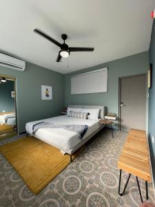 a bedroom with a bed and a ceiling fan at La Buena Vida Inn in San Juan