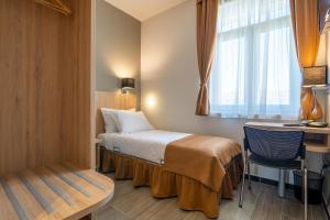 Posteľ alebo postele v izbe v ubytovaní Hotel Resurs