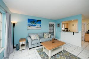 a living room with a couch and a table at Avenida Lower in Siesta Key