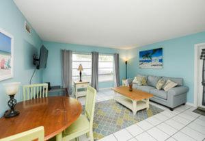 a living room with a table and a couch at Avenida Lower in Siesta Key