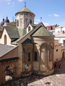 a large building with a tower and a church at Вірменський дворик / Armenian courtyard in Lviv