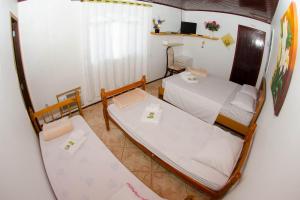 Postel nebo postele na pokoji v ubytování Suítes Recanto das Orquídeas