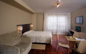 a bedroom with a bed and a desk at Apartamentos Attica21 Portazgo in A Coruña