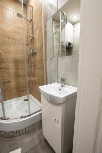 a bathroom with a sink and a shower at Apartament Estakada 2 in Częstochowa