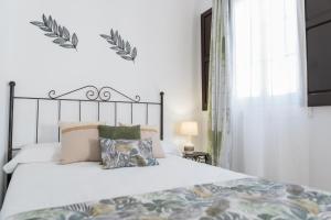 Postel nebo postele na pokoji v ubytování La Gitanilla Alojamiento & Encanto Jerez