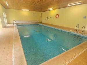 a large swimming pool in a room at The Smithy in Tenby