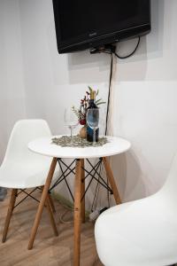 mesa con 2 sillas y TV en la pared en Apartament Estakada en Częstochowa