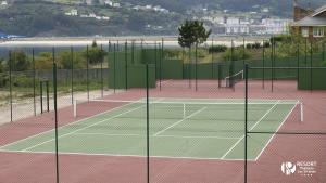 a tennis court with two tennis courts at Apartamentos Las Sirenas in Viveiro