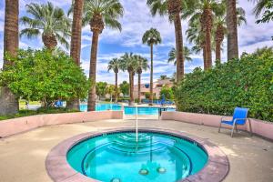 a pool with a fountain with palm trees at Resort Amenities Updated Palm Springs Villa in Palm Springs